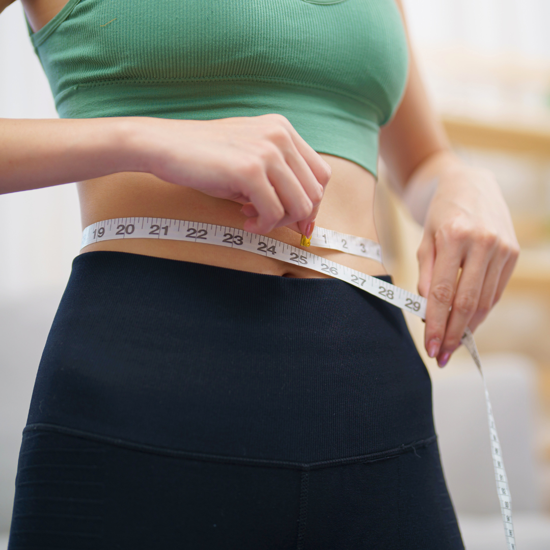 woman measuring weight loss